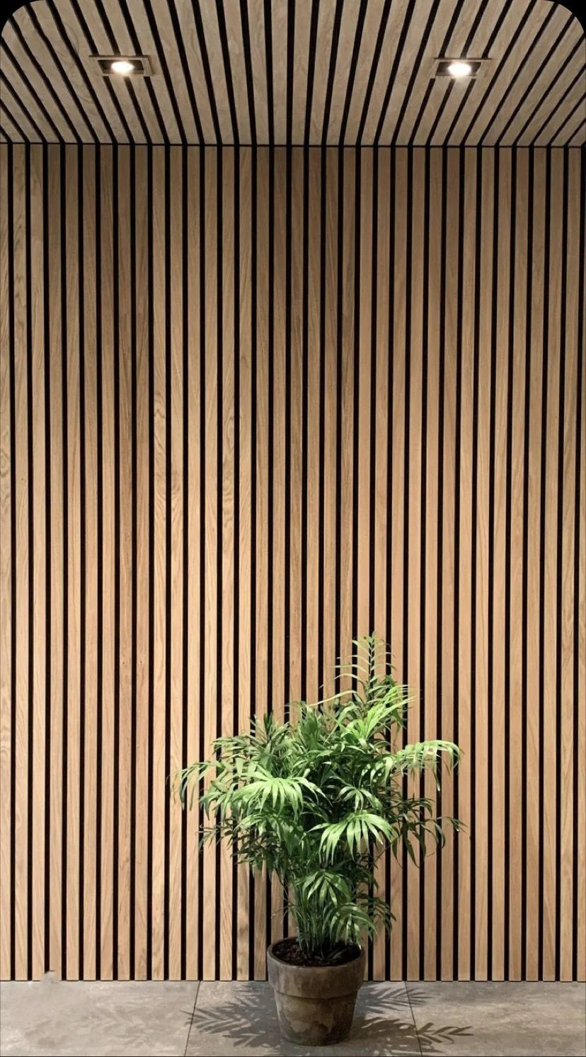 Installed dark oak HDF acoustic slatted wall panels 60x240cm in a UK interior by Solid Furniture UK, showcasing a stylish and acoustically enhanced space.