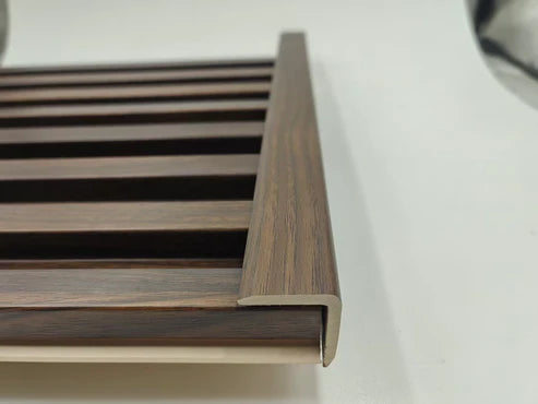 Dark oak WPC wall panel end trim UK by Solid Furniture UK showing premium wood-effect finish and precise edging profile for seamless wall panel installation