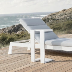 Dasia sun lounger with matching side table in a UK outdoor garden setting from Solid Furniture UK