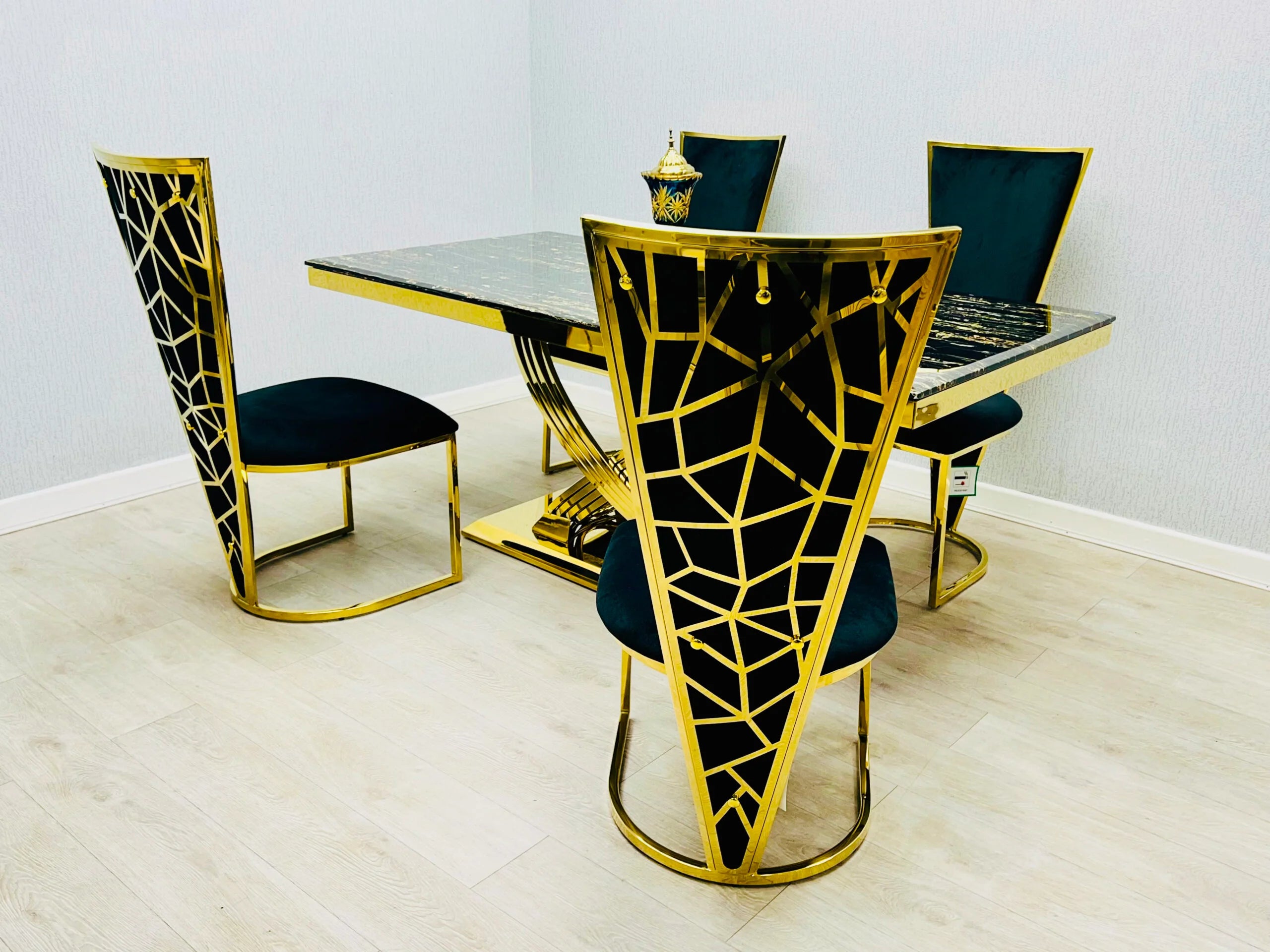 Side view of Elina black and gold dining table with chairs showing seating arrangement and elegant contemporary design. solid furniture UK