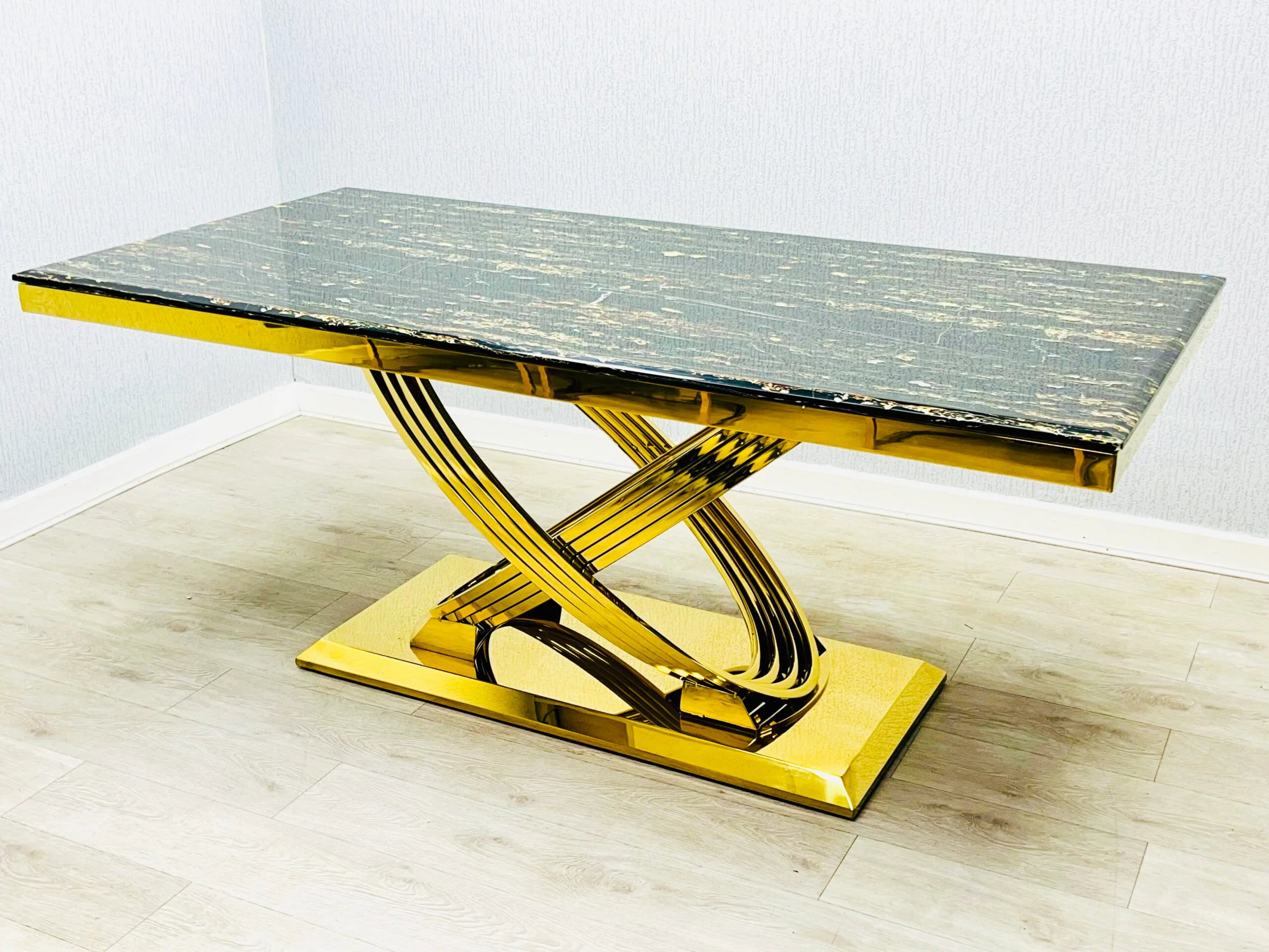 Angled view of Elina marble dining table in black and gold finish highlighting its luxurious tabletop and gold metal frame. solid furniture UK