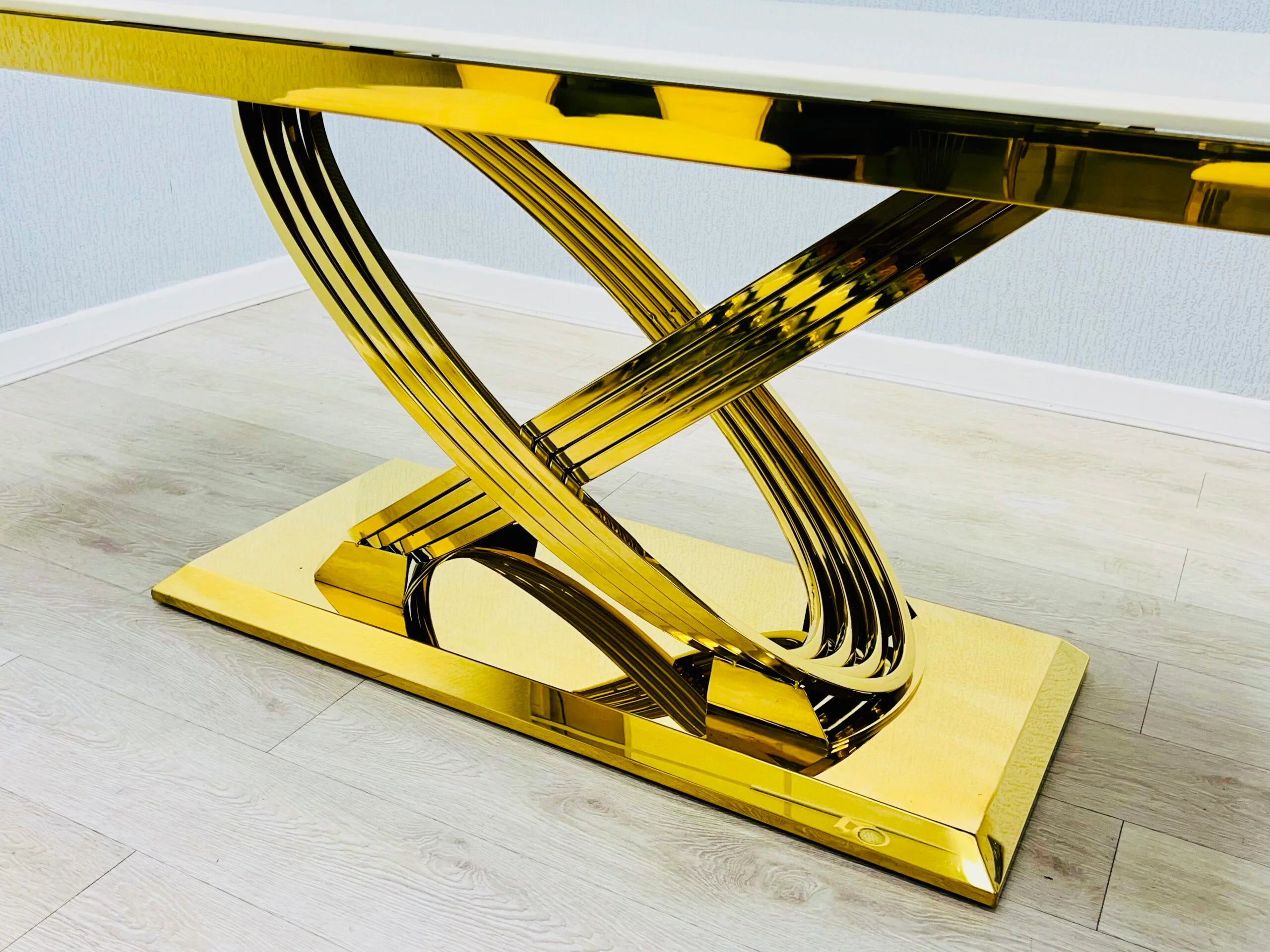 Angled base view of Elina black and gold marble dining table highlighting the sturdy gold-coated metal frame and luxurious modern design detail. solid furniture UK