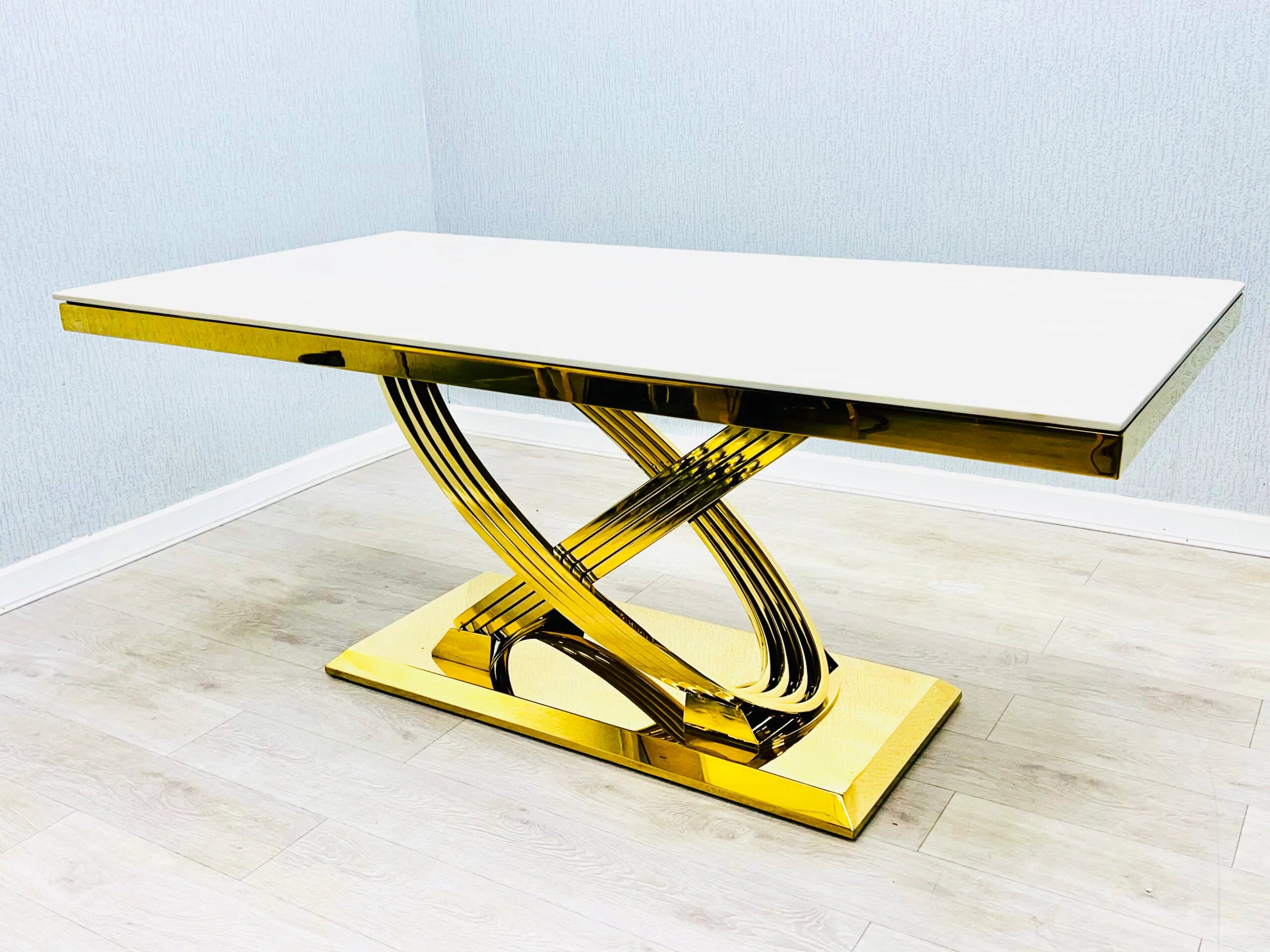Side view of Elina white and gold dining table with chairs showing seating arrangement and refined contemporary design. solid furniture UK