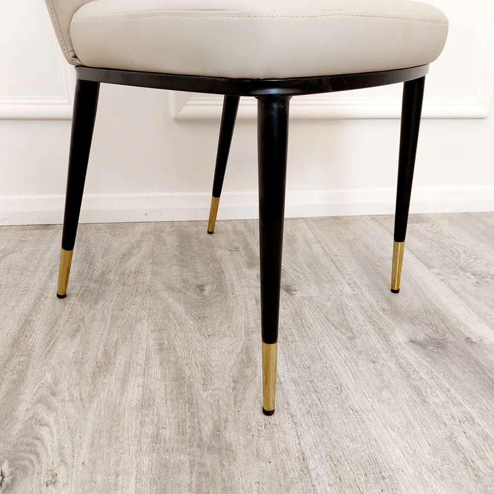 Etta beige leather dining chair legs detail view at Solid Furniture UK