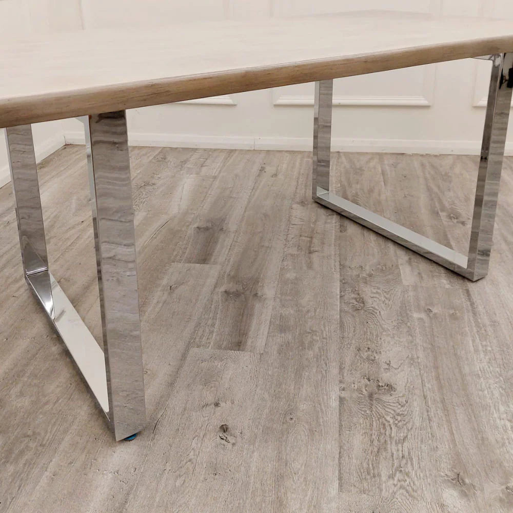 Close-up view of Freya dining table chrome metal base Solid Furniture UK