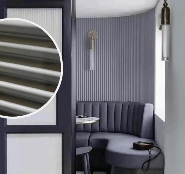 Grey fluted WPC wall panels installed on a living room feature wall by Solid Furniture UK creating a modern interior design look