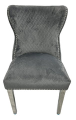 Grey velvet dining chair with button tufted back and lion knocker detail Solid Furniture UK