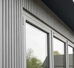 Grey WPC outdoor wall panels installed on a modern garden wall creating a sleek and contemporary finish solid furniture UK