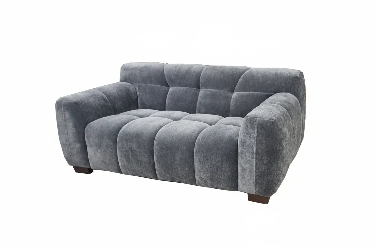 Harlem 2 seater sofa in steel velvet fabric, front main view with soft curved arms and deep channel stitched design, modern UK sofa furniture solid furniture UK