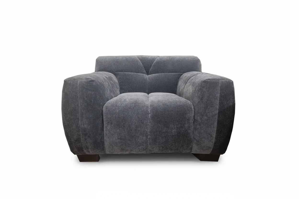 Harlem armchair in steel velvet, front view showing deep padded seat, curved arms and channel stitching, luxury UK accent chair solid furniture UK