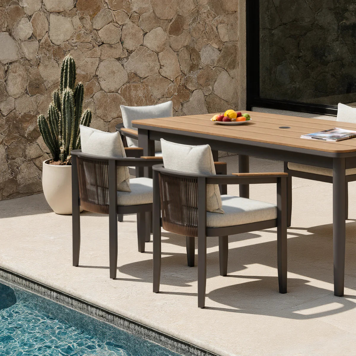 Hemera 6 seater outdoor garden dining set side view showing dining table and chairs, modern aluminium patio furniture set designed for stylish garden dining and outdoor use solid furniture UK