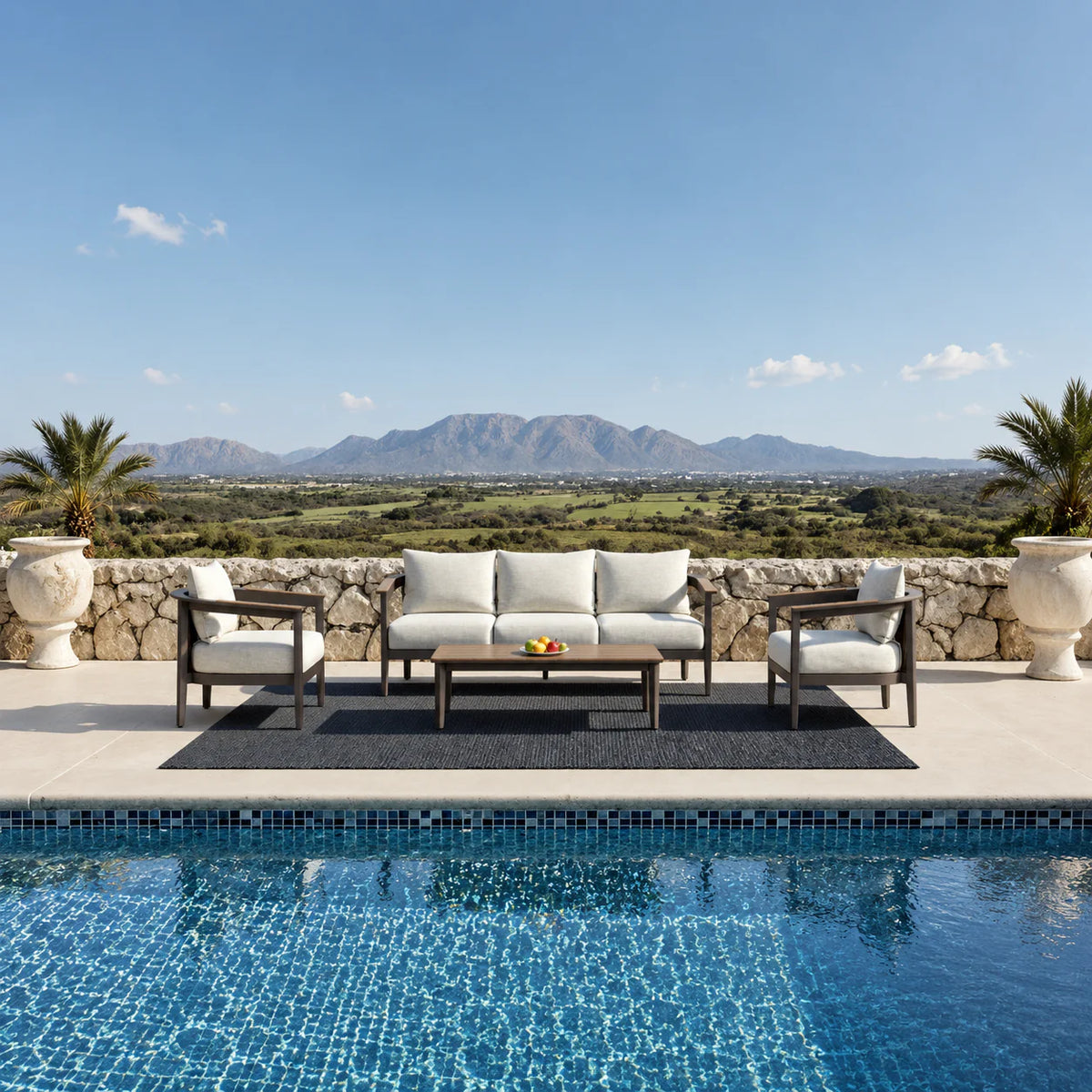 Hemera Wood 5 seater outdoor garden lounge set with sofa, chairs and coffee table, featuring mountain hills background and luxury pool view in a modern patio setting solid furniture UK