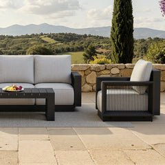 Ikos Onyx 5 seater outdoor lounge set side view showing sofa and chairs, modern aluminium garden furniture with cushioned seating solid furniture UK