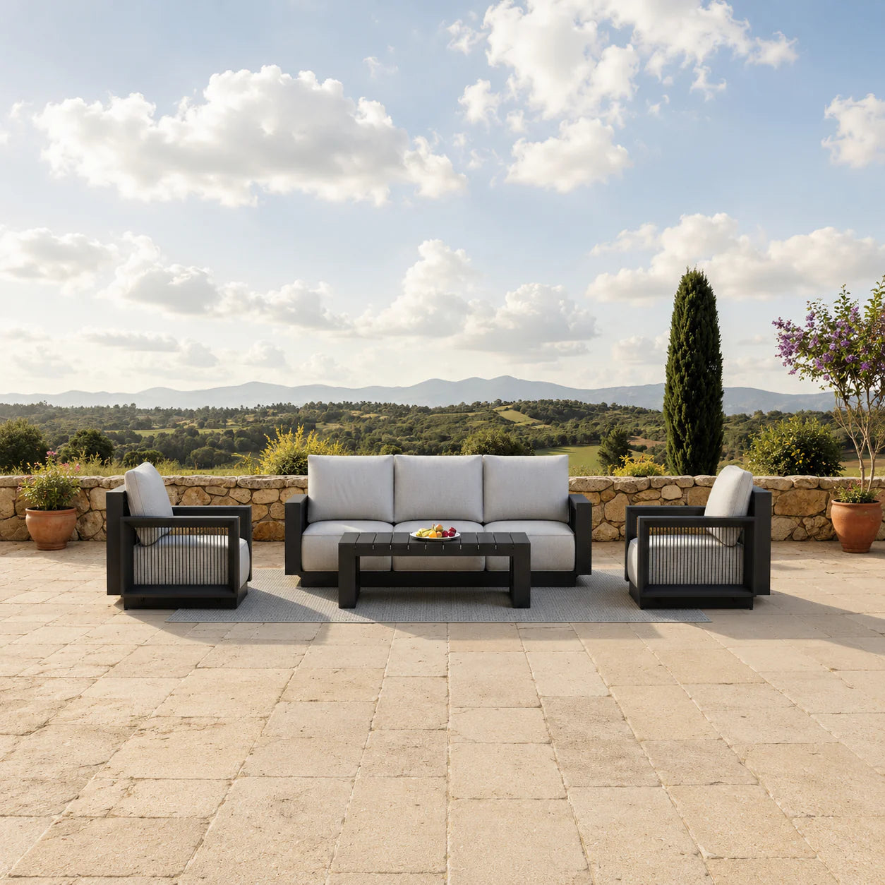 Ikos Onyx 5 Seater outdoor garden lounge sofa set with mountain hills view in the background, modern aluminium patio furniture for stylish UK gardens solid furniture UK