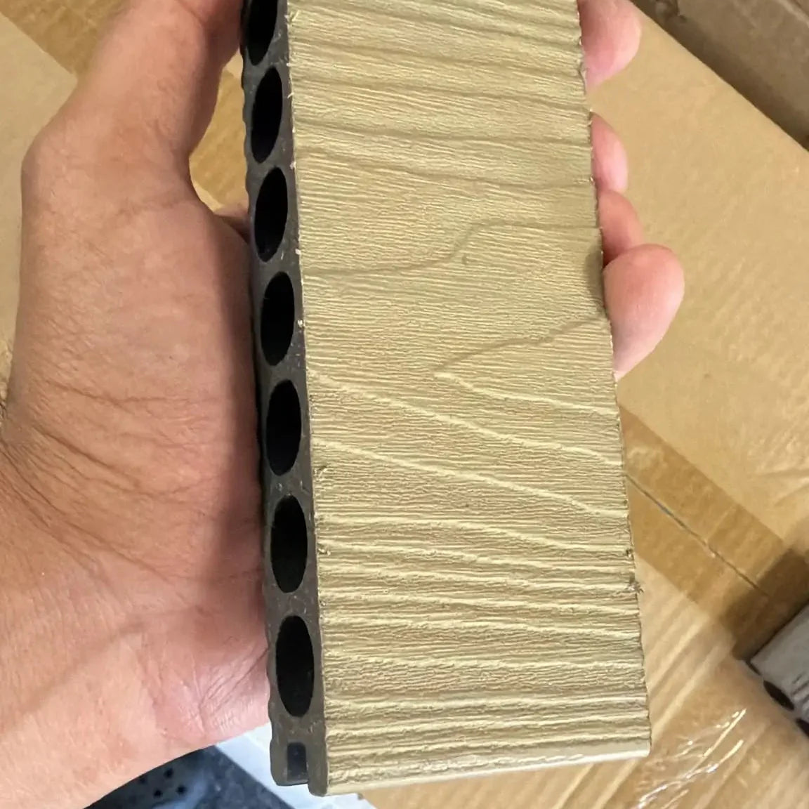 Close-up view of khaki composite decking wood-effect texture by Solid Furniture UK