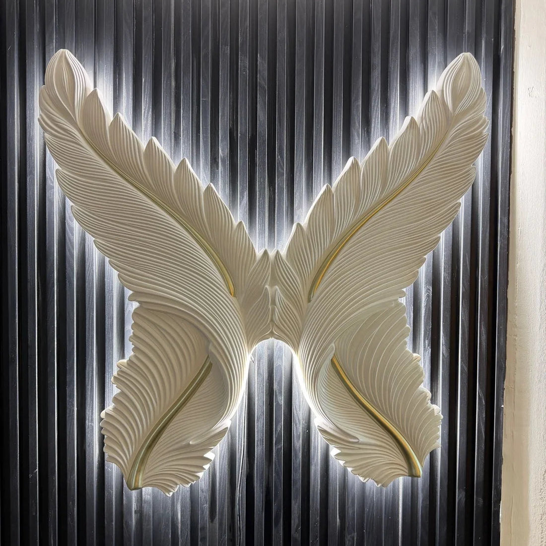 LED Wings Decorative Wall Art illuminated with soft ambient lighting by Solid Furniture UK, creating an elegant focal point for modern interiors.