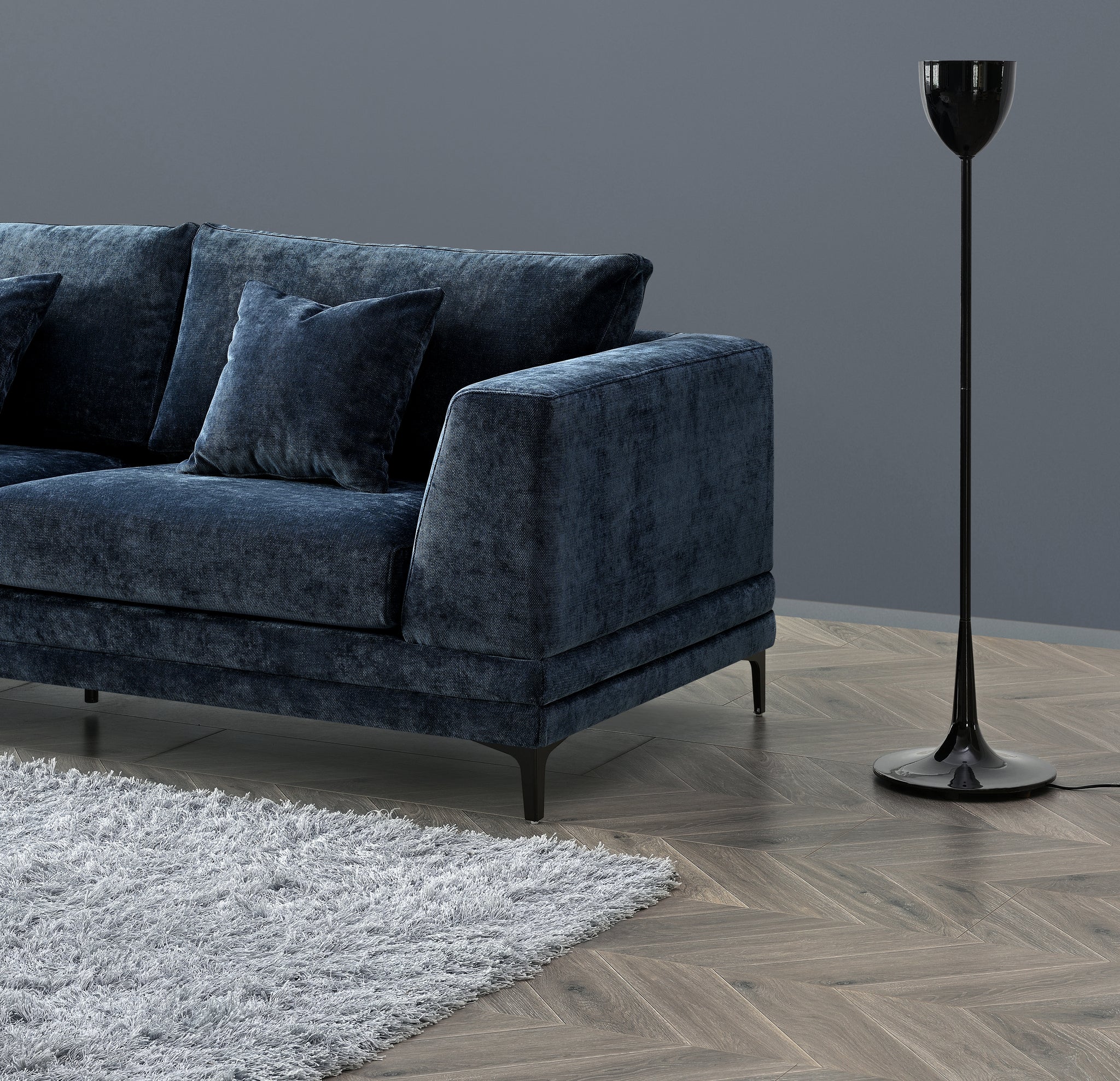 Side view of Lenox Aegean blue velvet sofa with clean mid-century lines and wooden plinth base solid furniture UK