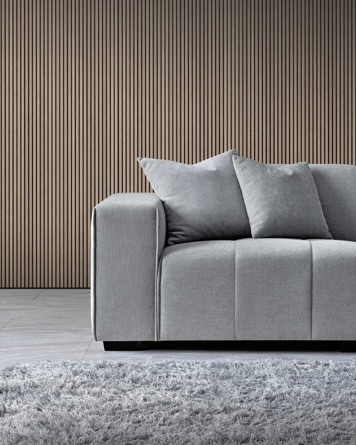 Side view of Leonard corner sofa showing block-stitched seat cushions and padded backrest