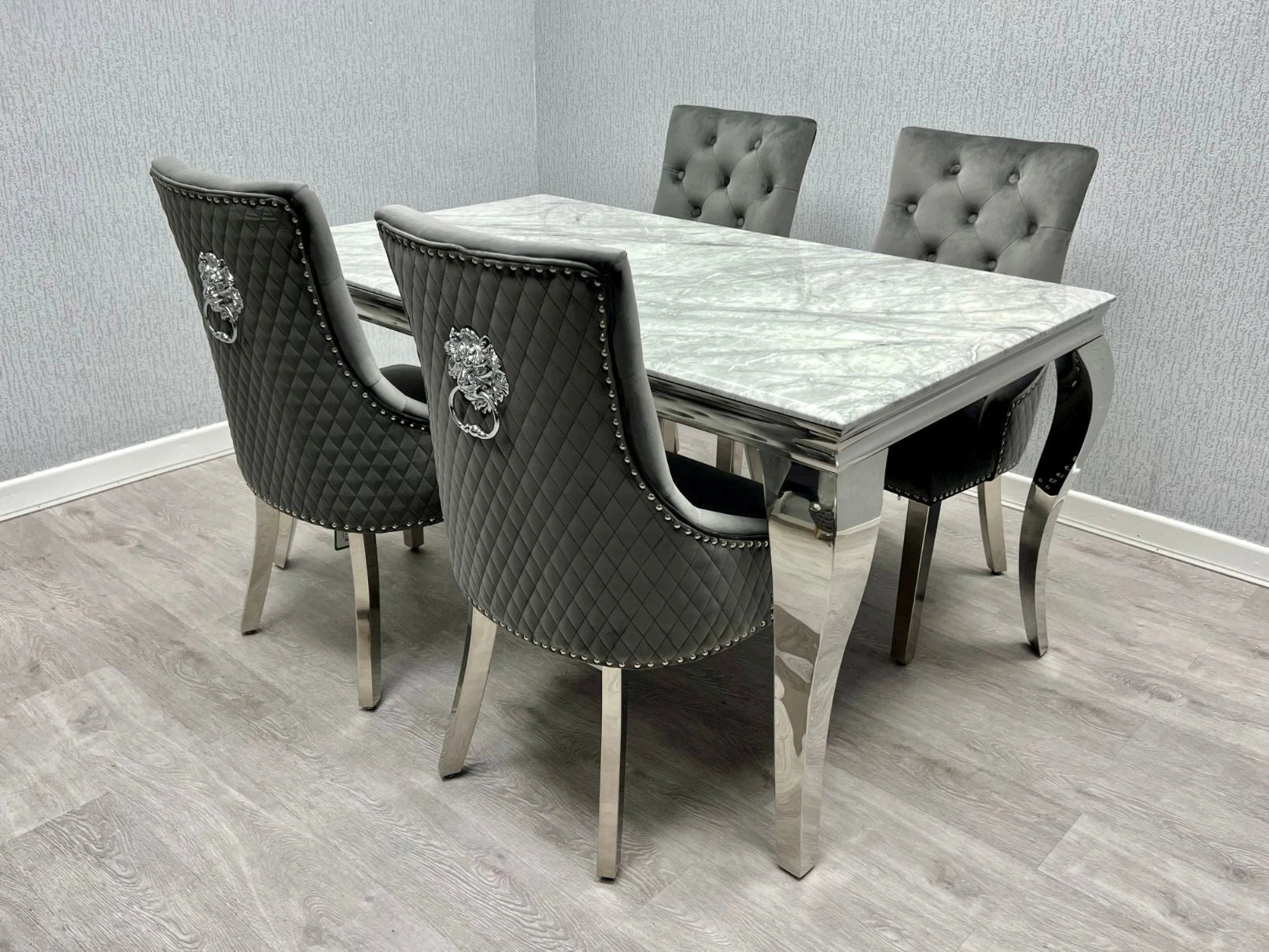 Modern Lewis Chrome Marble Dining Table with matching chairs, showcasing a luxury marble-effect tabletop and curved chrome stainless steel base in a contemporary dining room main view.