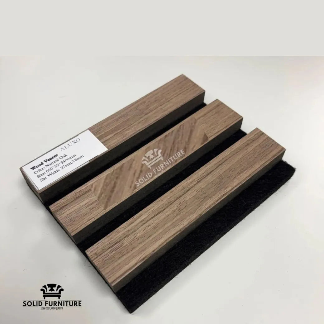Close-up of real wood light oak acoustic wall panel showing slat spacing, wood grain texture, and acoustic felt backing. Solid Furniture UK