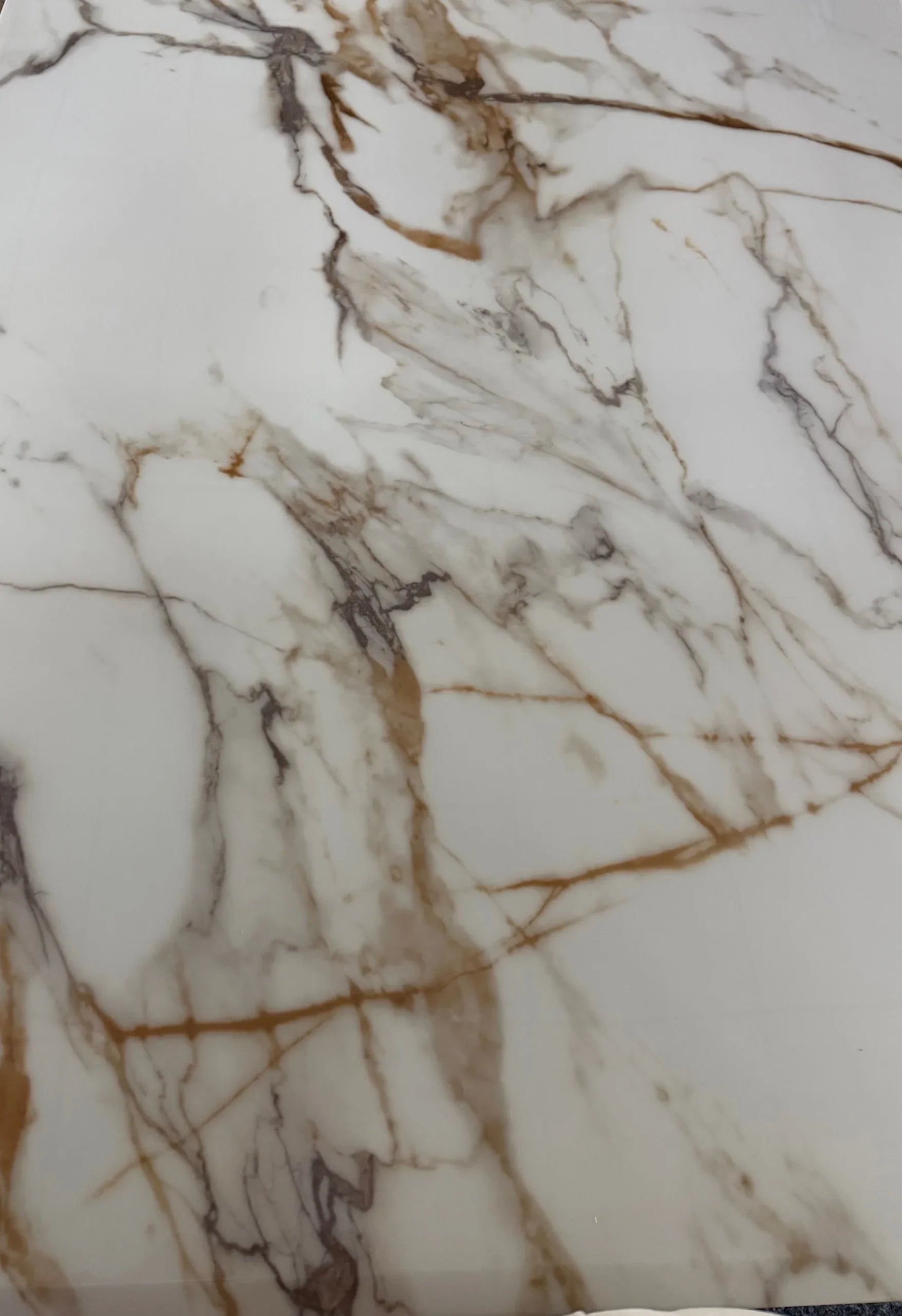 Close-up view of Louis gold marble dining table top Solid Furniture UK showing premium marble effect finish and smooth surface texture modern luxury design