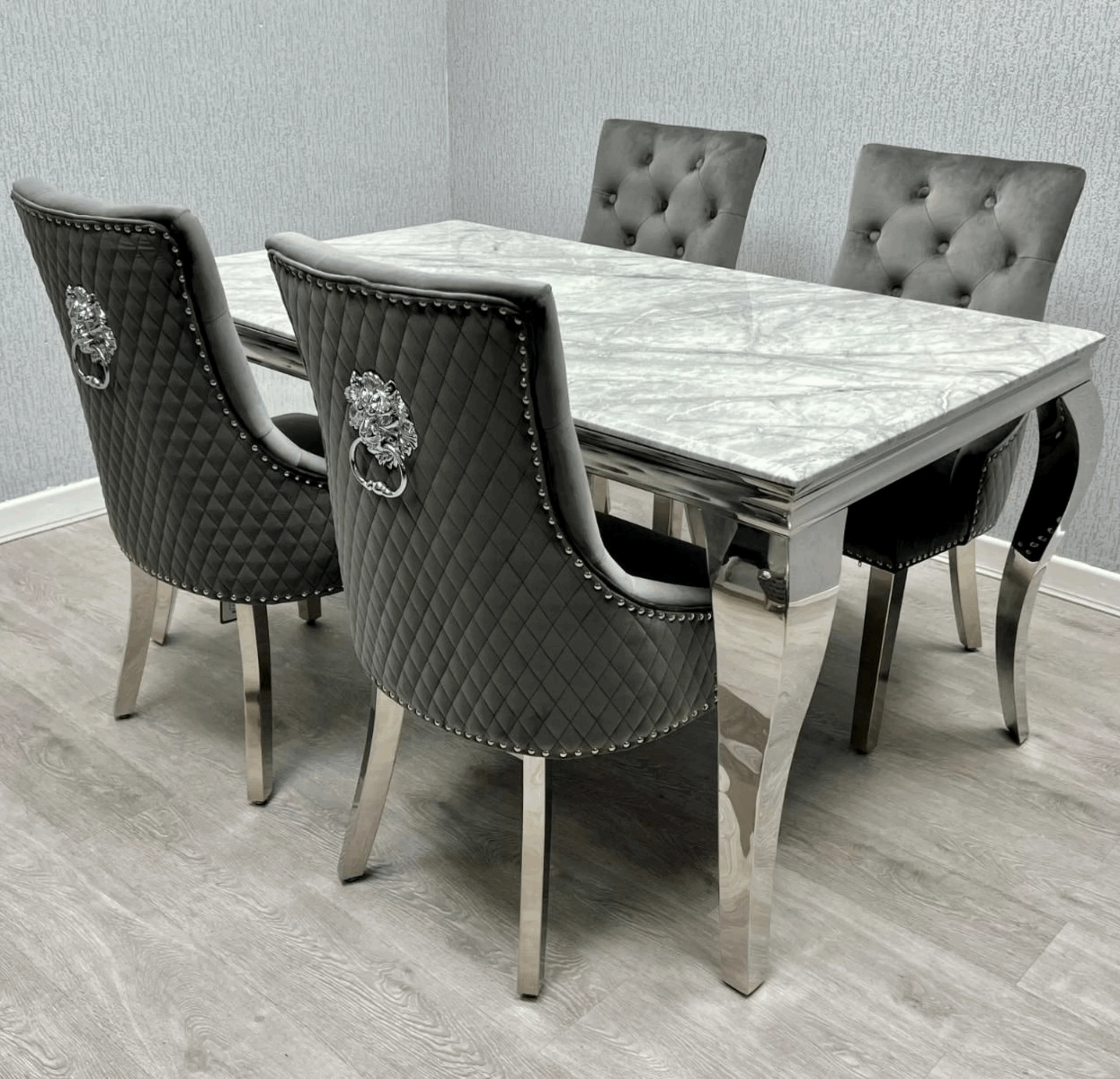 Side angle view of Louis Silver Grey marble effect dining table with grey Majestic velvet chairs from Solid Furniture UK