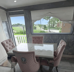 Side view of Louis white marble dining table with pink Majestic velvet dining chairs from Solid Furniture UK