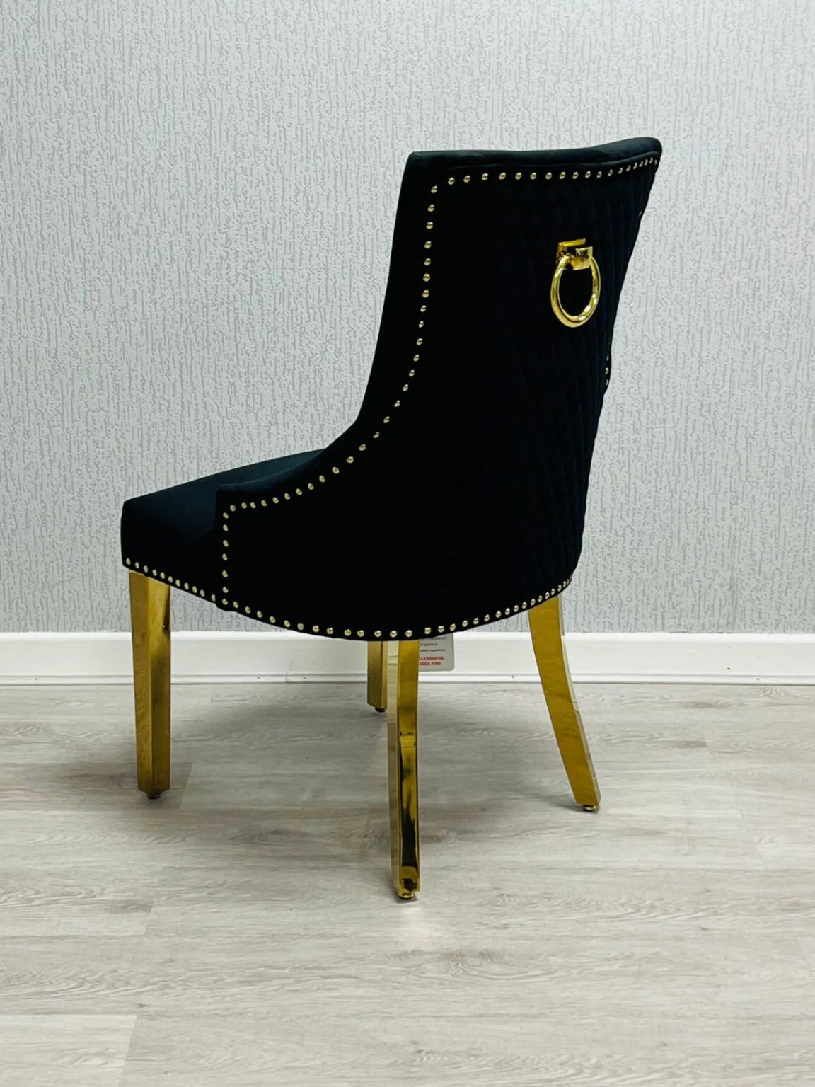 Side angle view of Majestic Black Gold upholstered dining chair highlighting premium design from Solid Furniture UK