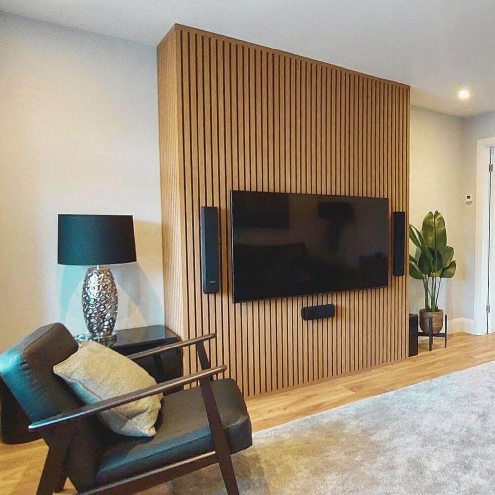 TV lounge in the UK with natural oak acoustic slatted wall panels 60x240cm by Solid Furniture UK, enhancing acoustics and modern interior design.