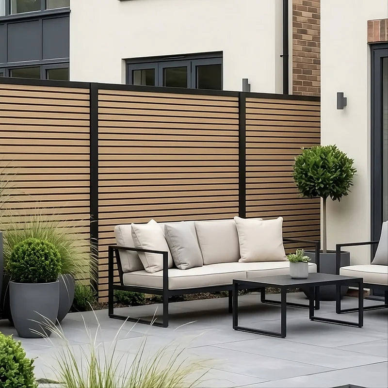 Oak composite fence panels installed alongside a contemporary patio by Solid Furniture UK.