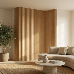 Oak Flute flexible wood veneer wall panels installed on a modern curved wall in a living room, showing natural oak finish and seamless acoustic design. solid furniture UK