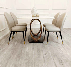 Orion Gold 1.8m dining table with Etta beige leather dining chairs side view at Solid Furniture UK