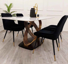 Side view of Orion Gold dining table and Black Luna chairs from Solid Furniture UK showing complete set layout and design details