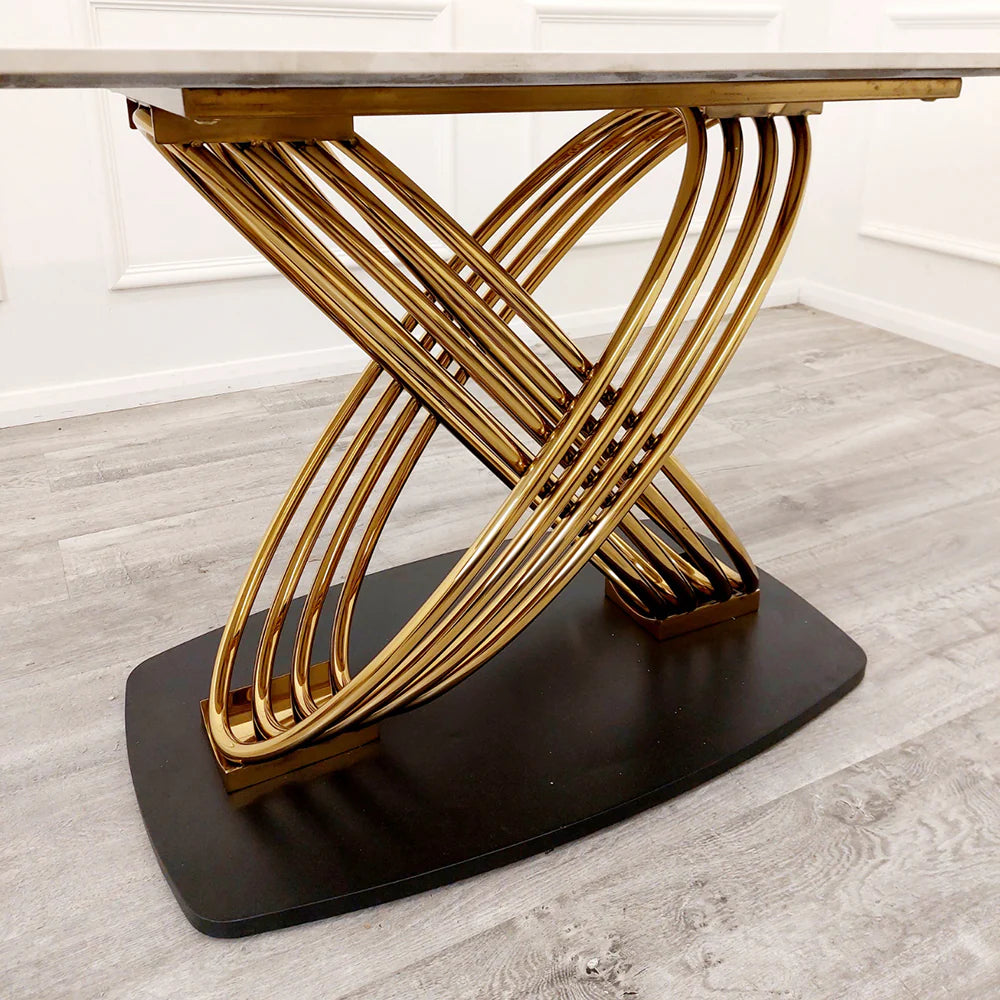 Close view of Orion Gold dining table pedestal base from Solid Furniture UK with black finish and interlocking gold ring design