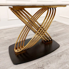 Close view of Orion Gold dining table pedestal base from Solid Furniture UK with black finish and interlocking gold ring design