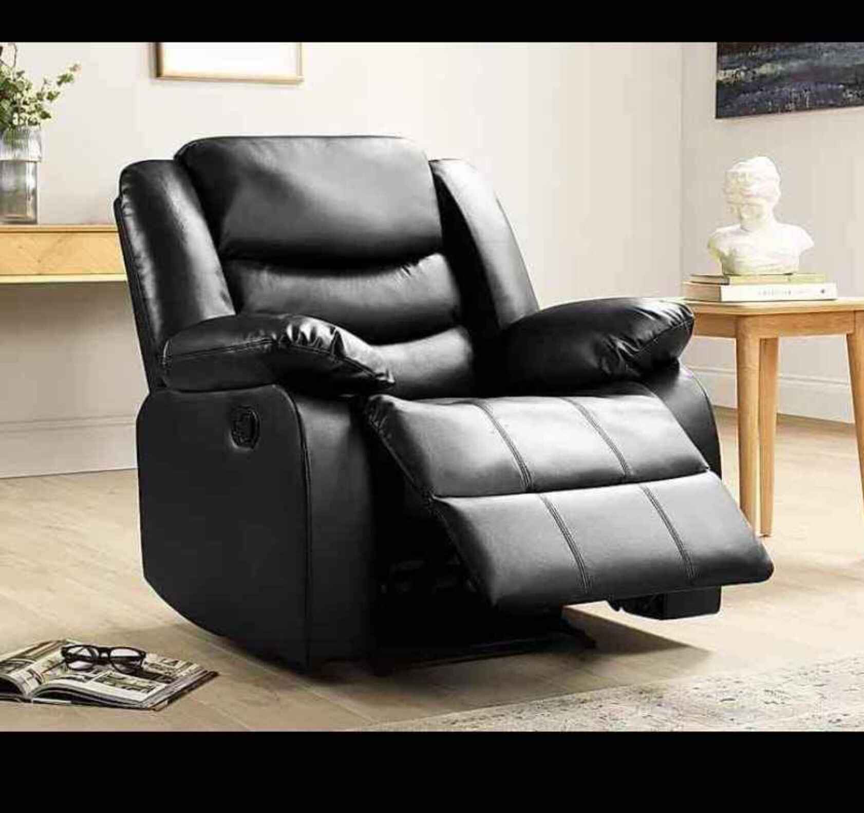 Front view of Roma black leather recliner single chair with padded armrests and sleek design SOLID FURNITURE LTD