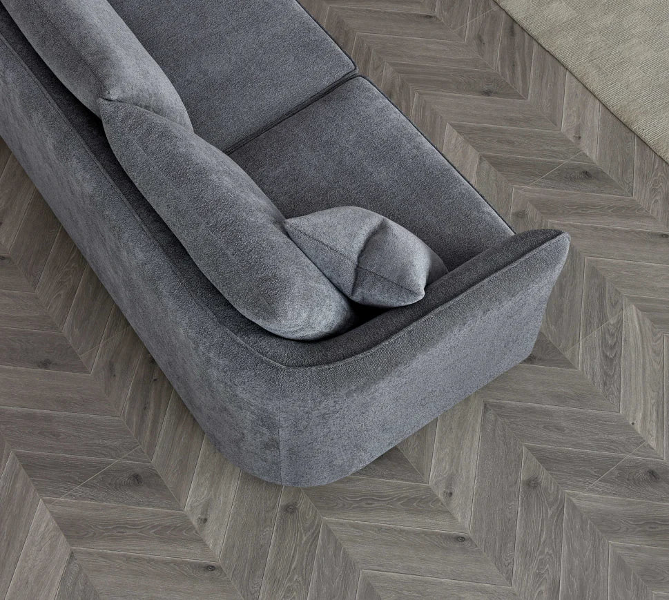 Angled view of Rubin charcoal bouclé corner chaise sofa with modern curved design solid furniture UK