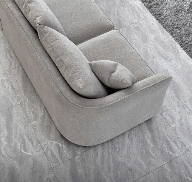 Angled view of Rubin modern pebble bouclé corner chaise sofa solid furniture UK