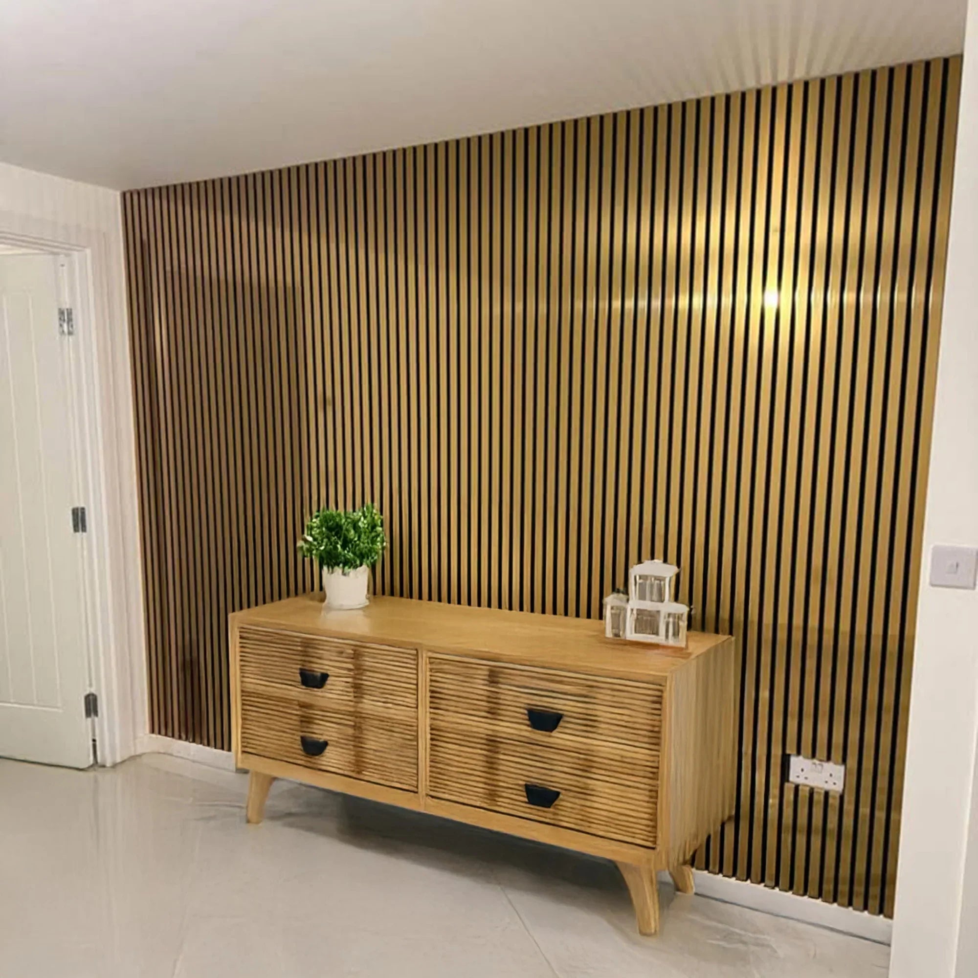 Shiny gold acoustic wall panels by Solid Furniture UK installed in a modern UK living room, creating a luxurious reflective feature wall with improved sound comfort