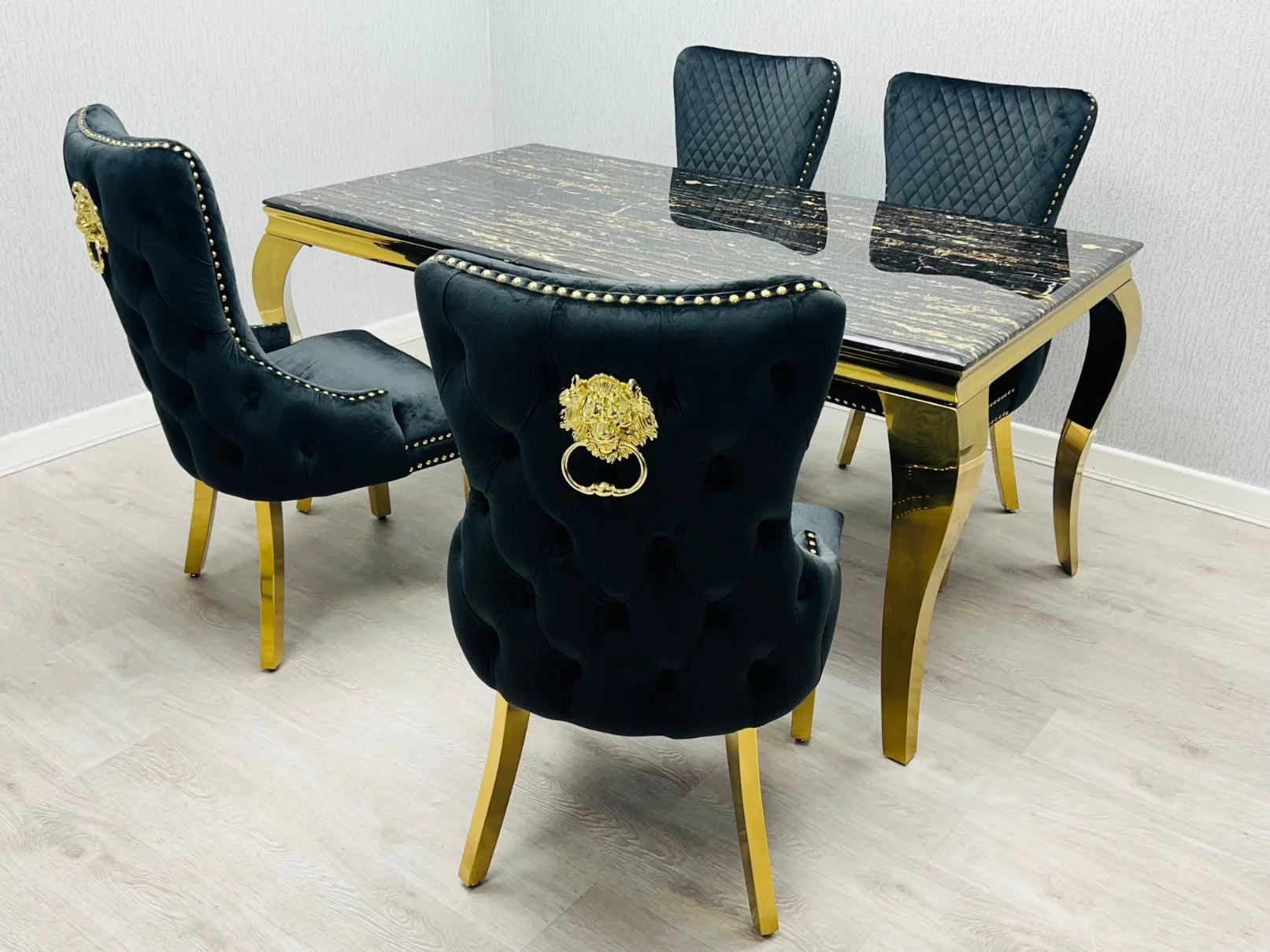 Black and gold Sofia Marble Dining Table with matching upholstered dining chairs in luxury dining space solid furniture UK
