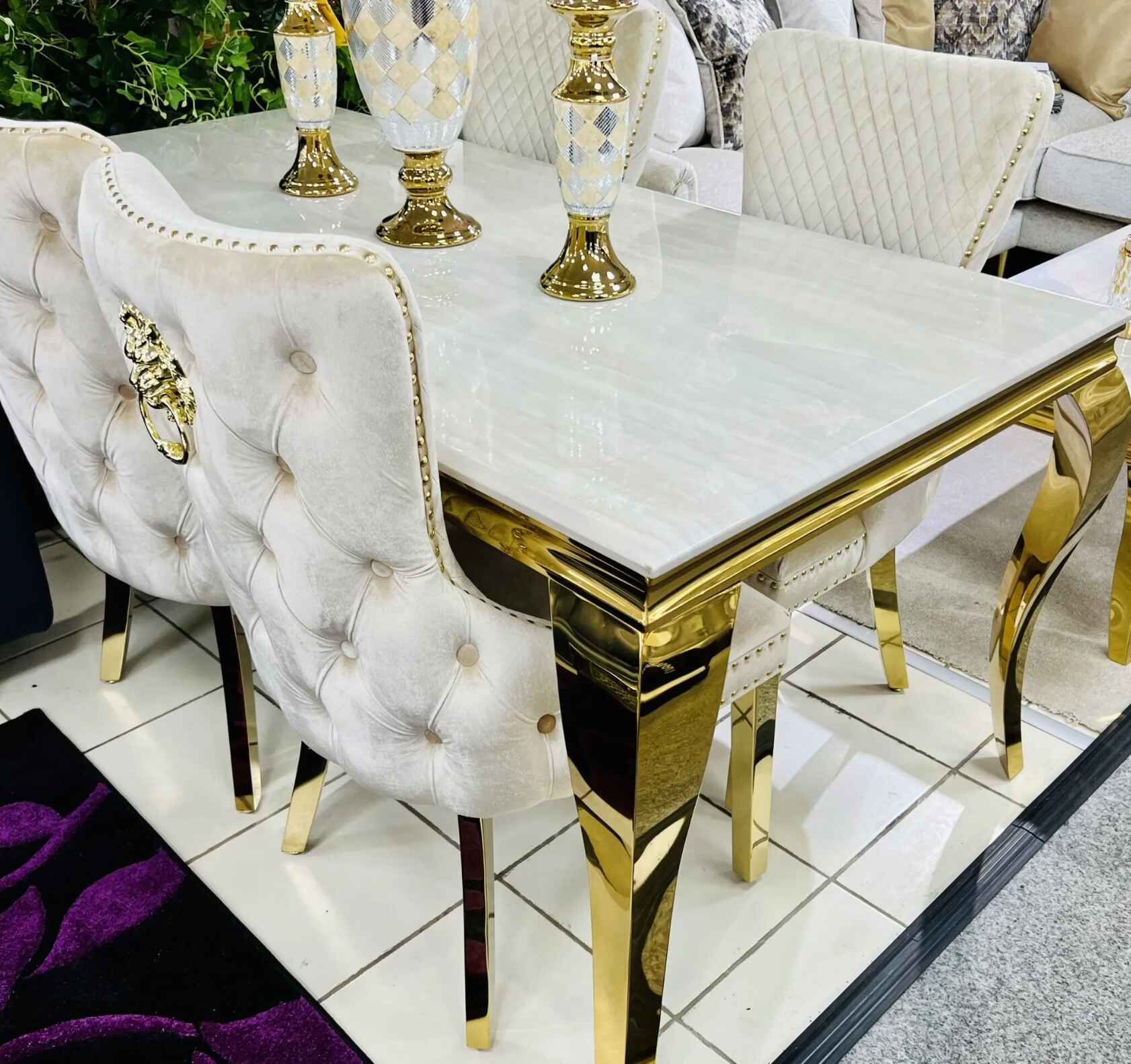 White marble Sofia Gold Dining Table with gold base and upholstered dining chairs in elegant modern interior solid furniture UK