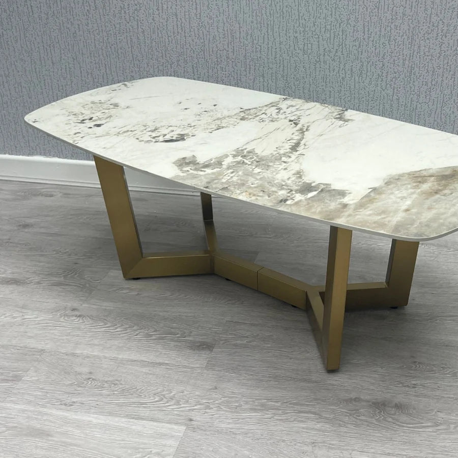 Sorrento oval coffee table side view with cream and gold ceramic top and gold frame | Solid Furniture UK
