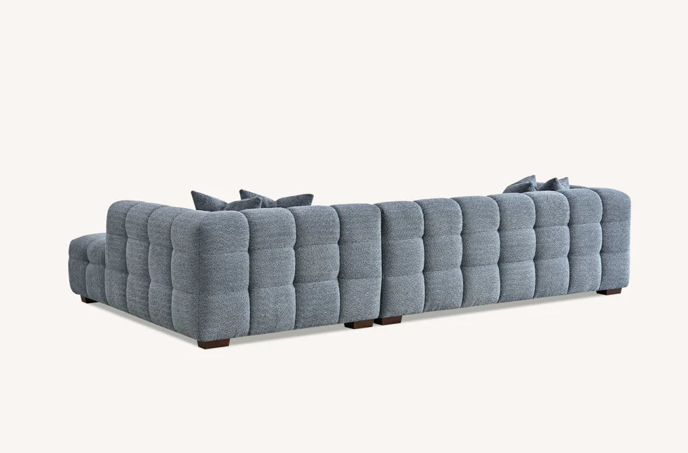 Back view of the Tribeca Corner Group sofa, showing the iron bouclé upholstery and sturdy construction from behind solid furniture UK