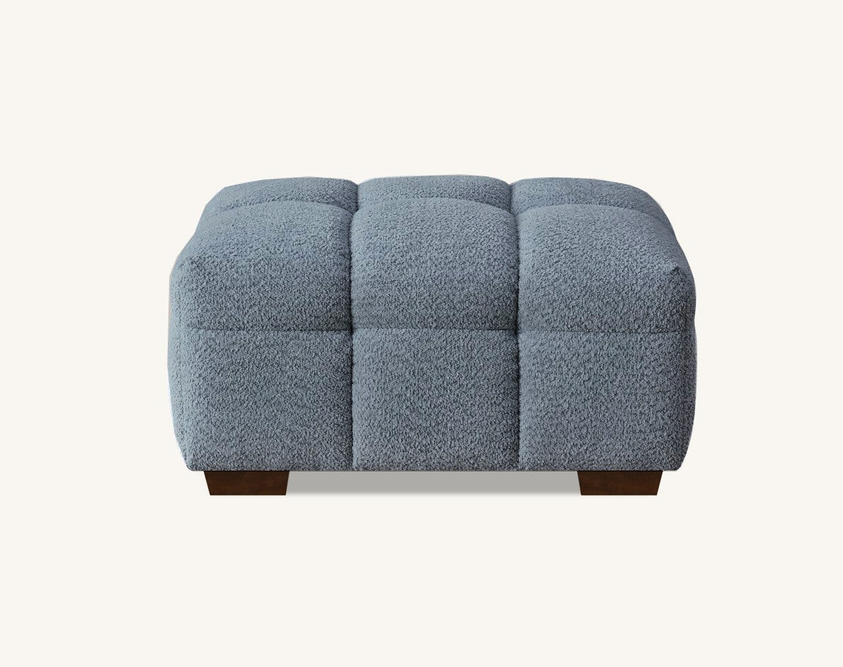 Matching footstool of the Tribeca Corner Group set in iron bouclé fabric, complementing the corner sofa and chaise