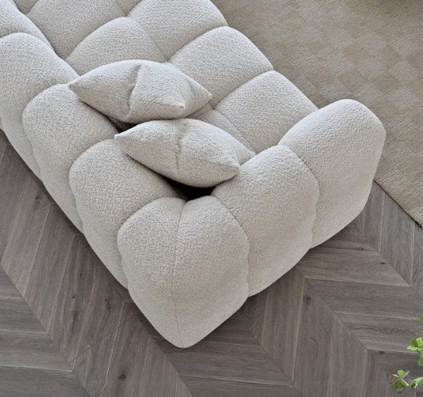 Angled corner view of Tribeca RHF corner sofa in oatmeal bouclé highlighting spacious seating - SOLID FURNITURE LTD