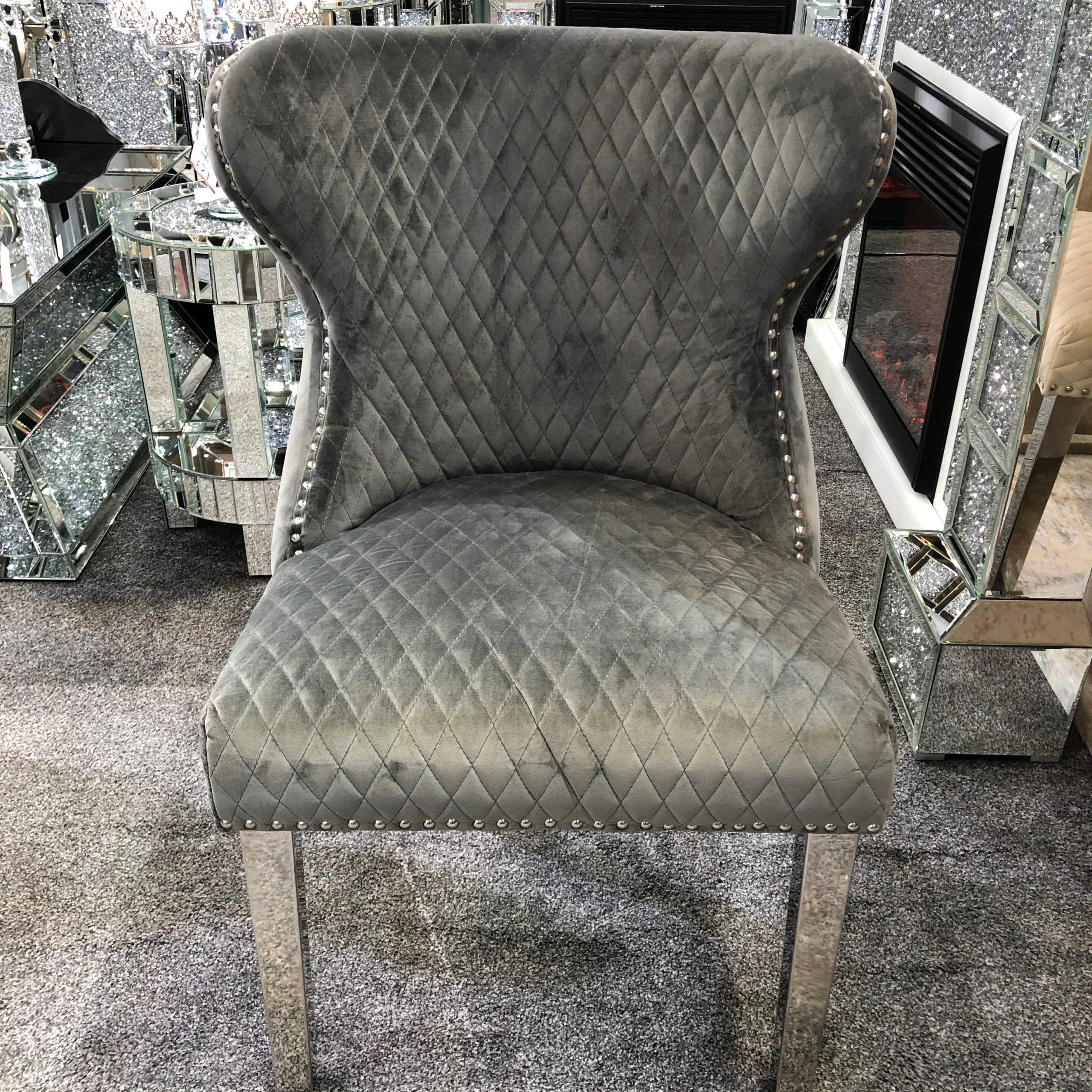 Valentino grey velvet dining chair front view with lion knocker Solid Furniture UK