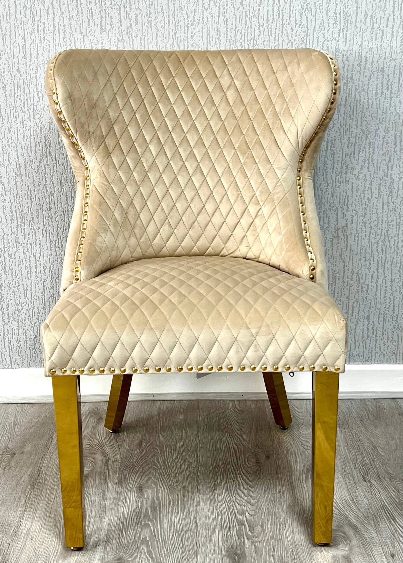Main front view of Valentino mink velvet dining chair featuring ring knocker detail, gold-finished legs and luxury upholstered design by solid furniture uk