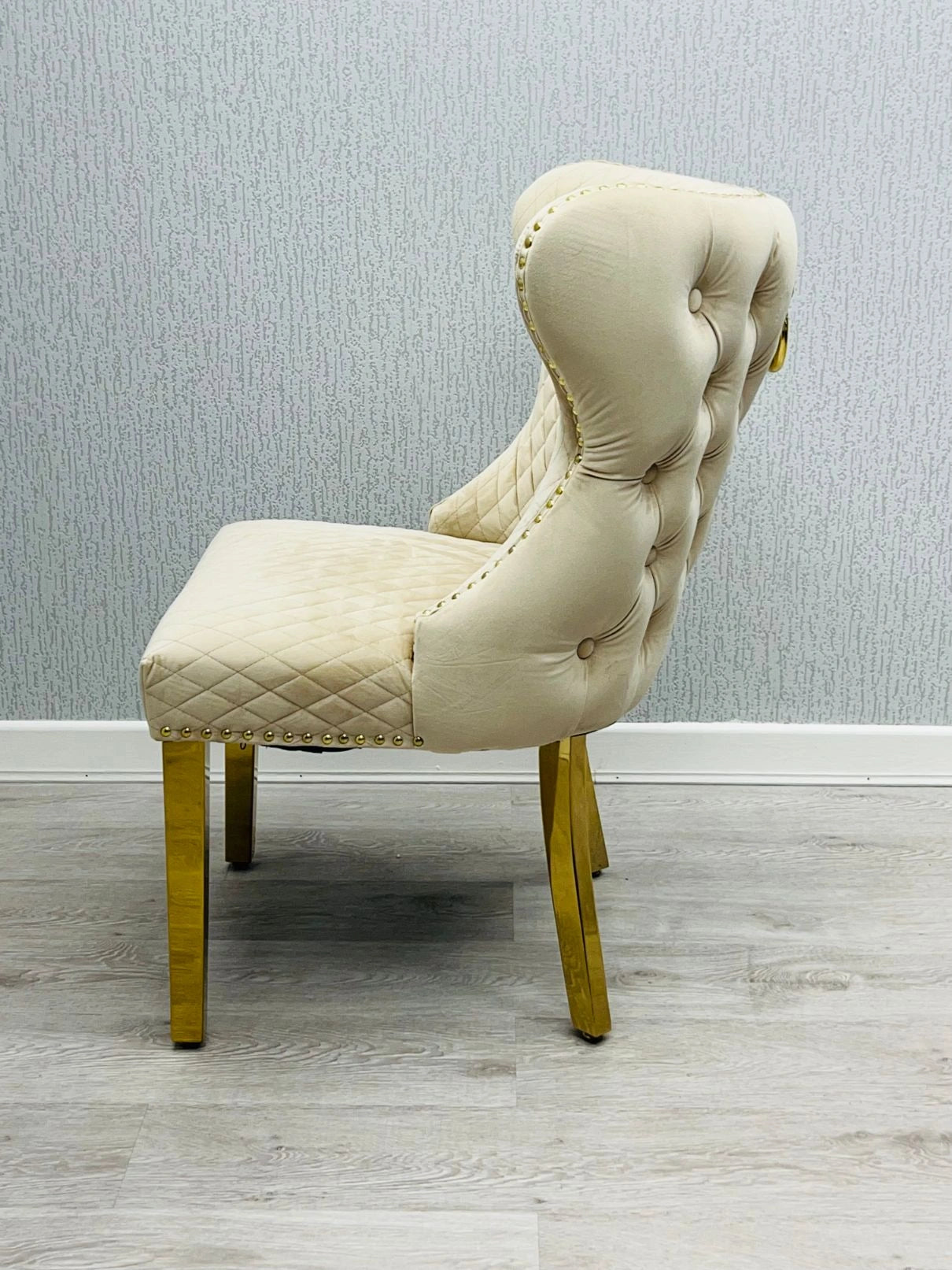 Side view of Valentino mink velvet dining chair featuring ring knocker detail, gold-finished legs and luxury upholstered design by solid furniture uk