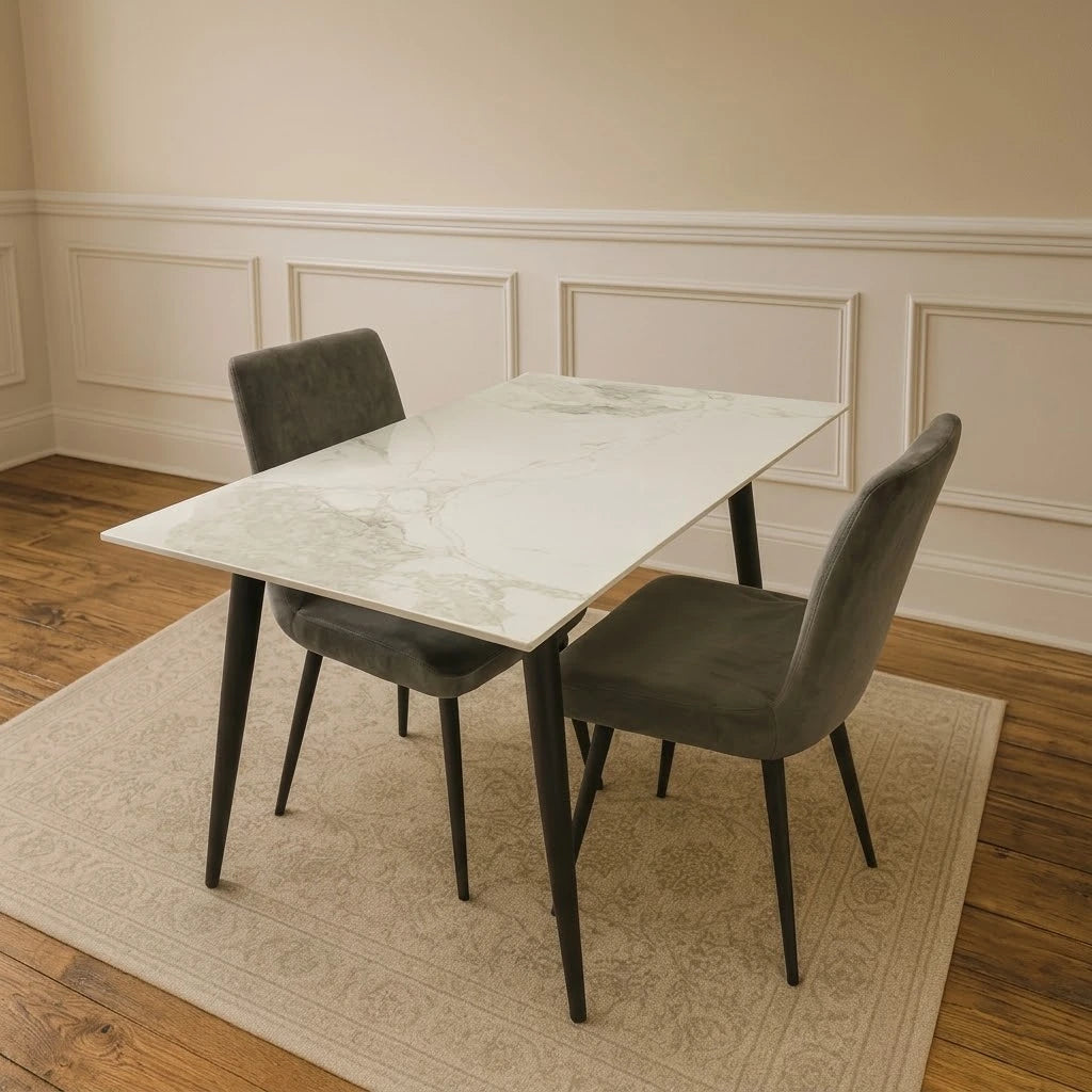 Venice ceramic dining table with black legs and chairs in a modern dining room by Solid Furniture UK