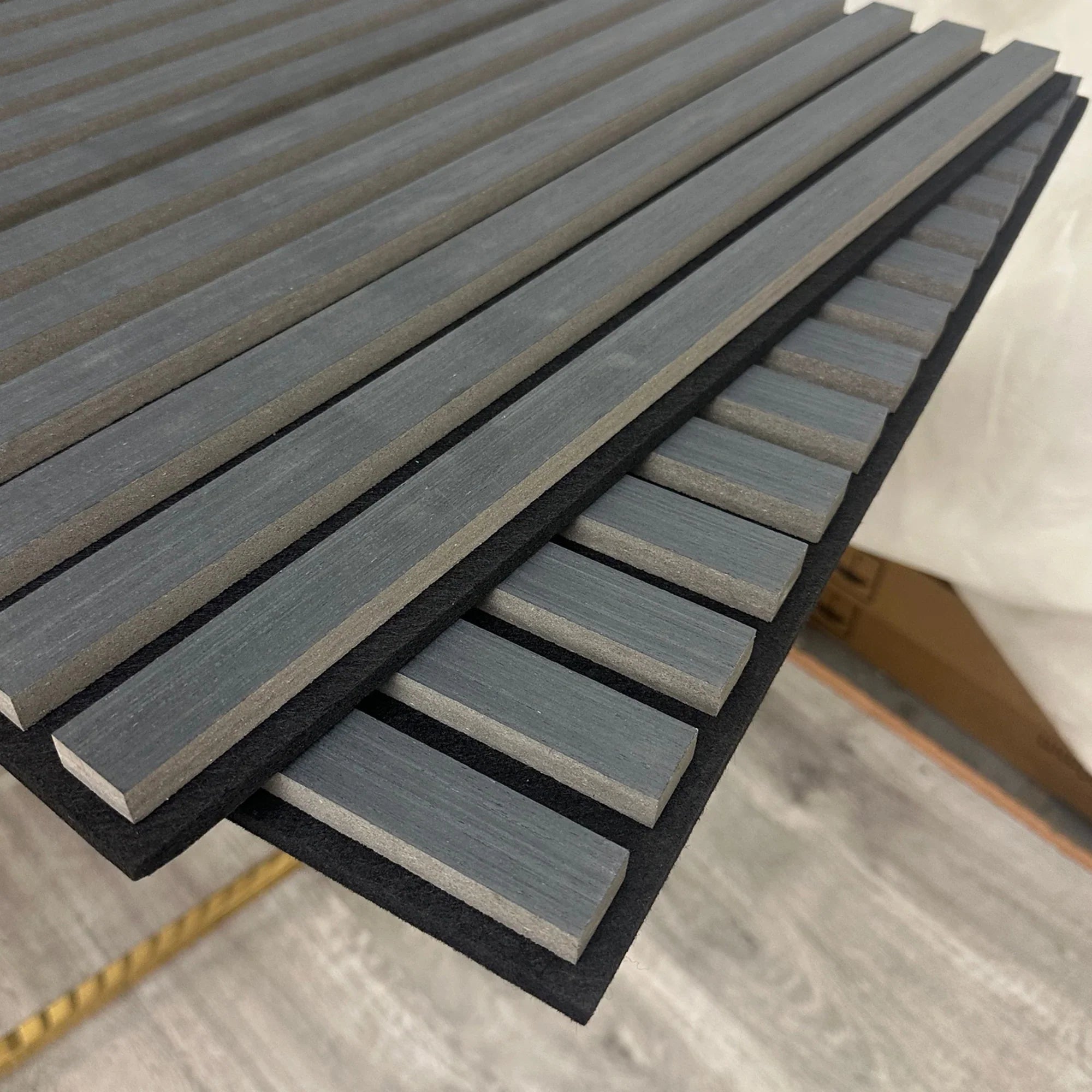 3D decorative angled view of a square acoustic charcoal black wall panel by Solid Furniture LTD showing slat detail, premium finish, and acoustic benefits.